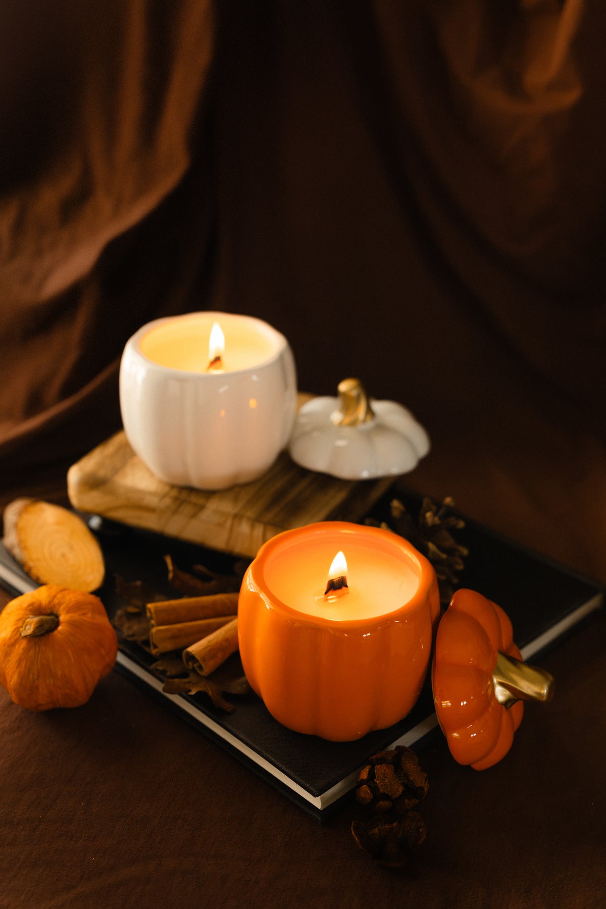 Orange and White Pumpkin Vessels with burning candles