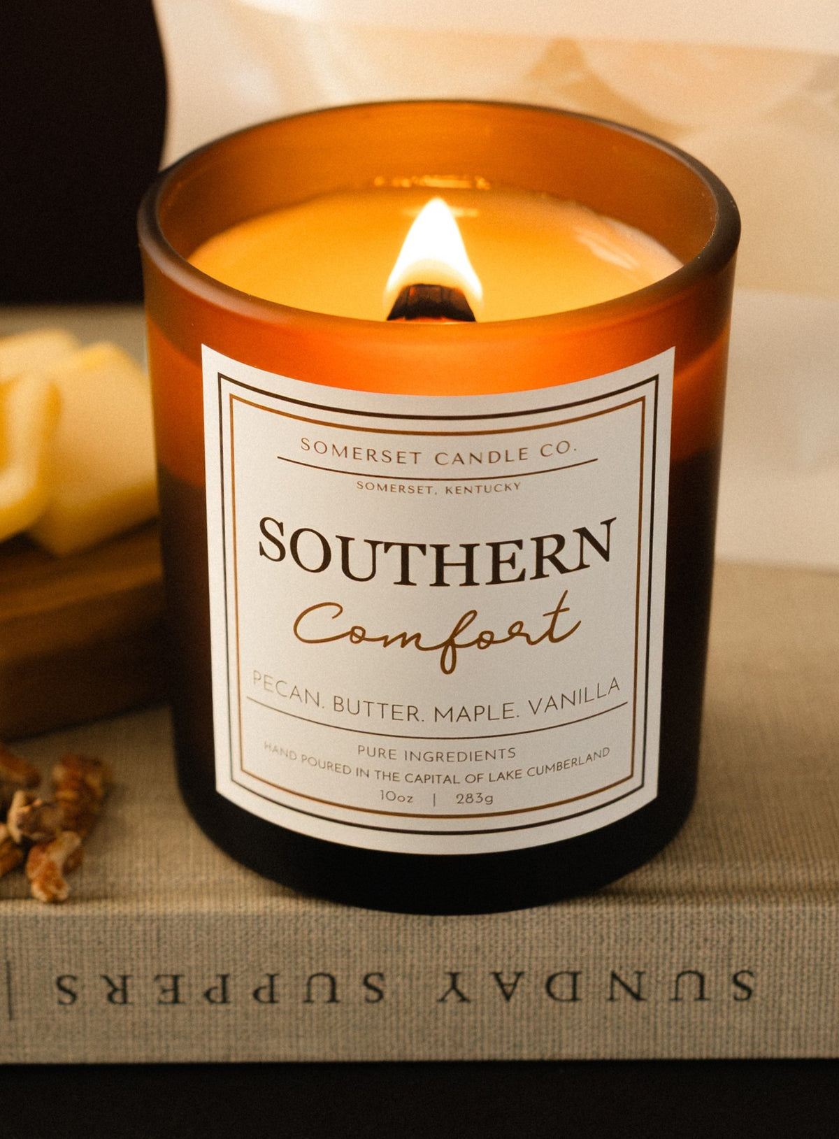 Southern Comfort Candle in Brown Vessel with burning flame