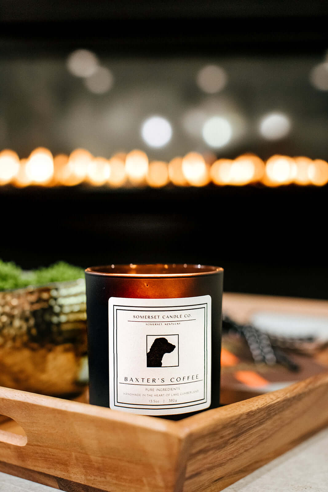 Baxter's Coffee Candle in front of a warm fireplace