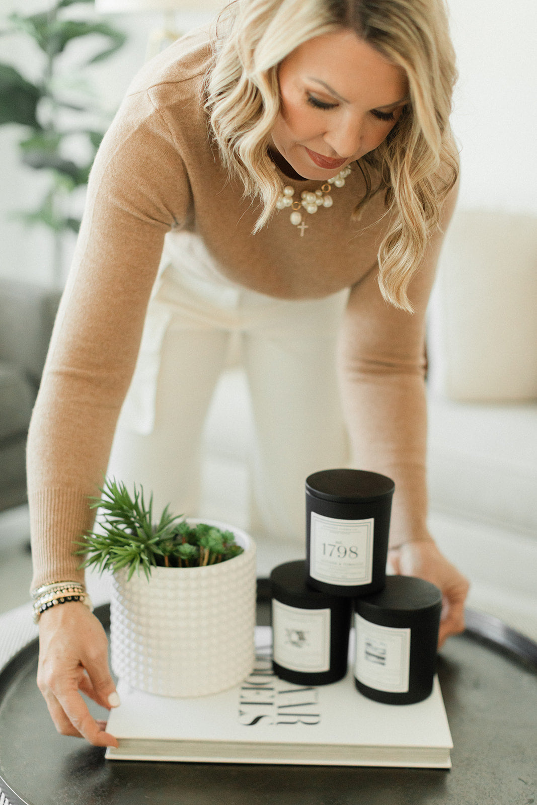 Courtney Ikerd placing Somerset Candles on Table